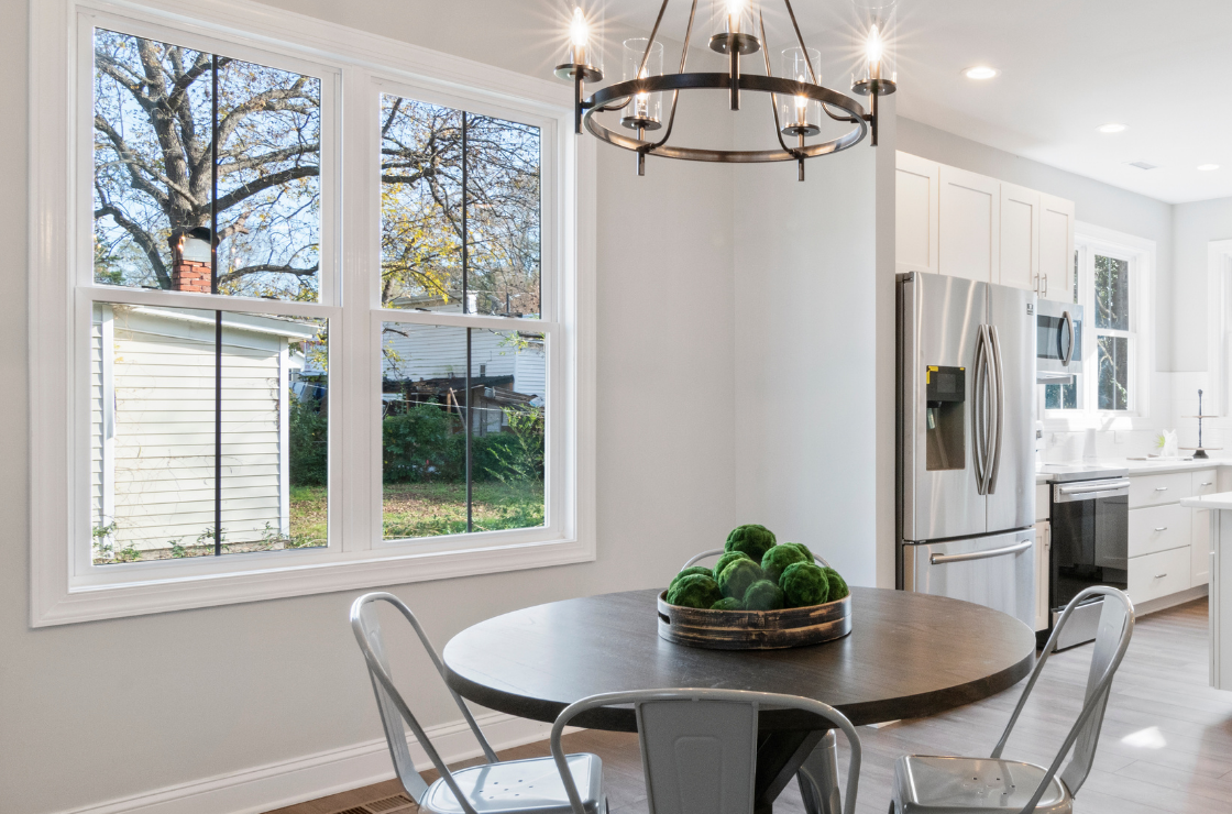 A small kitchen table sat beside a large window